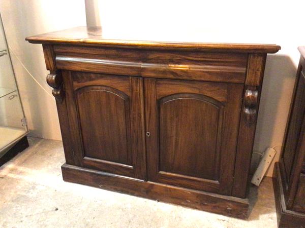 A modern side cabinet with moulded top above two frieze drawers and two panel doors with single