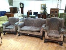 A 1920s/30s suite including a two seater sofa and lady's and gentleman's armchairs, all with