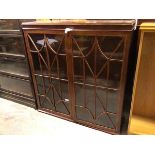 An Edwardian mahogany bookcase, with single adjustable shelf behind glazed doors, some panes