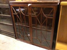 An Edwardian mahogany bookcase, with single adjustable shelf behind glazed doors, some panes