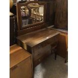 An Edwardian dressing table, the bevelled mirror with domed top, supports lacking finials, fitted