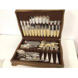 An oak serpentine front and side cutlery canteen, with a collection of Epns including forks,