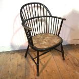 A late 19thc ebonised Windsor chair with upholstered seat on turned supports united by H