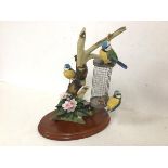 A Border Fine Arts sculpture of Three Bluetits on a Branch, bears stamp to base Birds by Russell