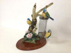 A Border Fine Arts sculpture of Three Bluetits on a Branch, bears stamp to base Birds by Russell