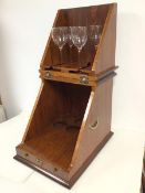 A wooden travelling cocktail or drinks cabinet, the hinged top enclosing an interior with hanging