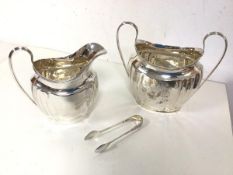 A 1920s Birmingham silver milk jug and a two handled sugar bowl with sugar nips (combined: 383.