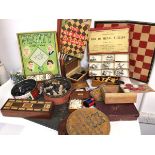 A collection of vintage games including sets of dominoes, chess pieces, ABC Game, Pegity, Chinese
