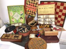 A collection of vintage games including sets of dominoes, chess pieces, ABC Game, Pegity, Chinese
