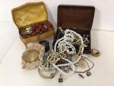 A collection of costume jewellery including imitation pearl necklaces, brooches, bangles, pill box