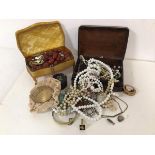 A collection of costume jewellery including imitation pearl necklaces, brooches, bangles, pill box