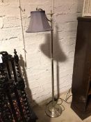 A modern floor reading lamp, the curved arm on metal stem and circular base (147cm)