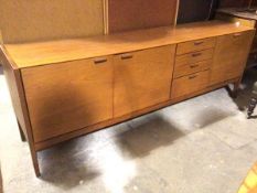 A mid century teak C& J Brown, Newington, Edinburgh sideboard with an arrangement of cupboards and