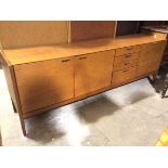 A mid century teak C& J Brown, Newington, Edinburgh sideboard with an arrangement of cupboards and