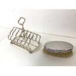 An Edwardian Birmingham silver backed clothes brush (13cm x 7cm) and an Epns large toastrack on