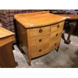 An early 20thc satinwood bow front chest of drawers with ledge back, the top with moulded edge above