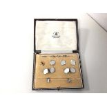 A set of 8ct and 9ct gold engine turned sleevelinks and studs, retailed by Mappin & Webb, in
