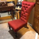 An Edwardian slipper chair in later button back brick red upholstery, on turned front supports
