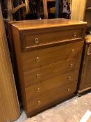 A mid century style teak chest of drawers, the top drawer with panelled front above four long