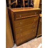 A mid century style teak chest of drawers, the top drawer with panelled front above four long