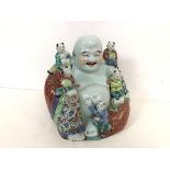 A handsome Chinese ceramic Seated Buddha with five children, all with elaborate polychrome decorated