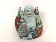 A handsome Chinese ceramic Seated Buddha with five children, all with elaborate polychrome decorated