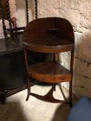 An Edwardian mahogany corner washstand, the high galleried back with corner shelf, with single tier,