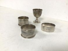 A collection of three Birmingham silver napkin rings and a Birmingham silver egg cup (combined: 61.