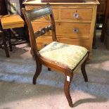 A Regency mahogany side chair with intricately carved mid rail above a drop in seat, with reeded