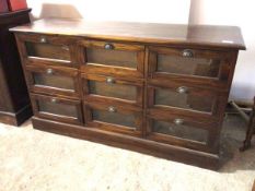 A modern shopkeeper's haberdashery cabinet, the moulded top above nine glazed drawers, each with