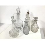 A collection of decanters including a tall claret jug with stopper (chip to foot) (37cm), a