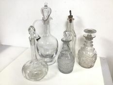 A collection of decanters including a tall claret jug with stopper (chip to foot) (37cm), a