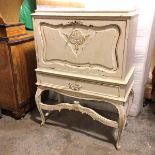 A Louis XV style white painted cocktail cabinet with fall front and interior fitted bottle