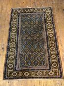 A North West Persian rug, the central panel with multiple stylised flowers in blues and yellows,