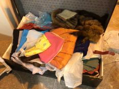 A vintage travelling trunk containing a quantity of mostly womenswear including vintage dresses,