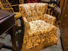 A low armchair in floral upholstery with button back (85cm x 67cm x 67cm)