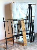 A brass and painted metal bed frame, the spindles on head and footboard topped with stylised