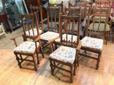 A set of six Ercol elm dining chairs, the architectural top rail on a spindle back, with upholstered