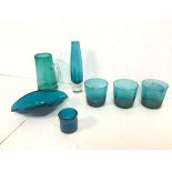 A collection of turquoise and teal glass including three tumblers (8cm x 8cm), a bud vase, a water