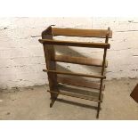 A middle to late 20thc wooden shoe or bookstand, with three tiers (90cm x 61cm x 26cm)