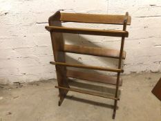 A middle to late 20thc wooden shoe or bookstand, with three tiers (90cm x 61cm x 26cm)