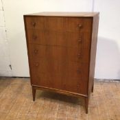 A mid century teak chest of drawers fitted five graduated drawers, on tapering supports