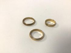 Three 9ct gold wedding bands (largest: W) (combined: 8.48g)