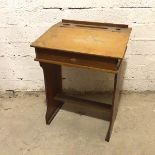A 1920s/30s child's school desk with the hinged slope top (70cm x 51cm x 41cm)