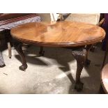 A 19thc mahogany dining table, the oval top with moulded edge on cabriole supports with acanthus