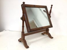 A late Victorian hinged dressing table mirror, the rectangular glass on two turned supports, on