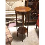 An Edwardian mahogany circular plant stand, the top with boxwood and kingwood chequered edge on