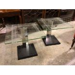 A pair of modern lamp tables with square etched glass tops on triangular mirrored stems and square