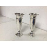 A pair of Edwardian Sheffield silver bud vases, with flared scalloped rim, maker B&S with wooden