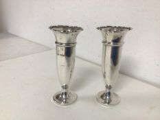 A pair of Edwardian Sheffield silver bud vases, with flared scalloped rim, maker B&S with wooden